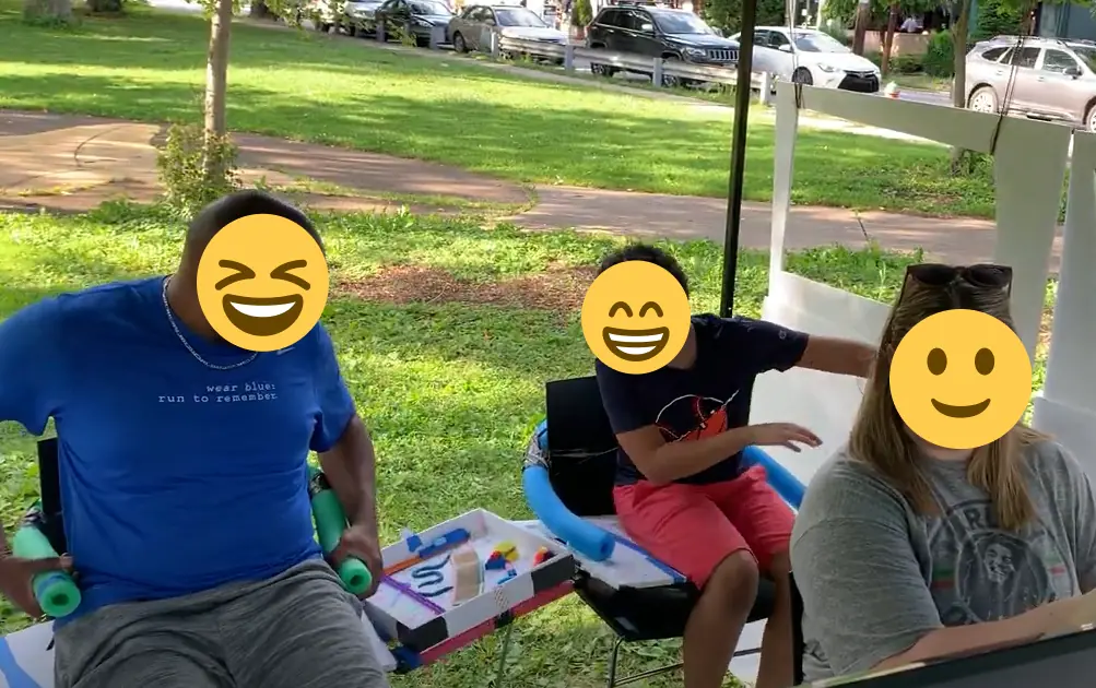 user research: family plays game in car simulator in a park